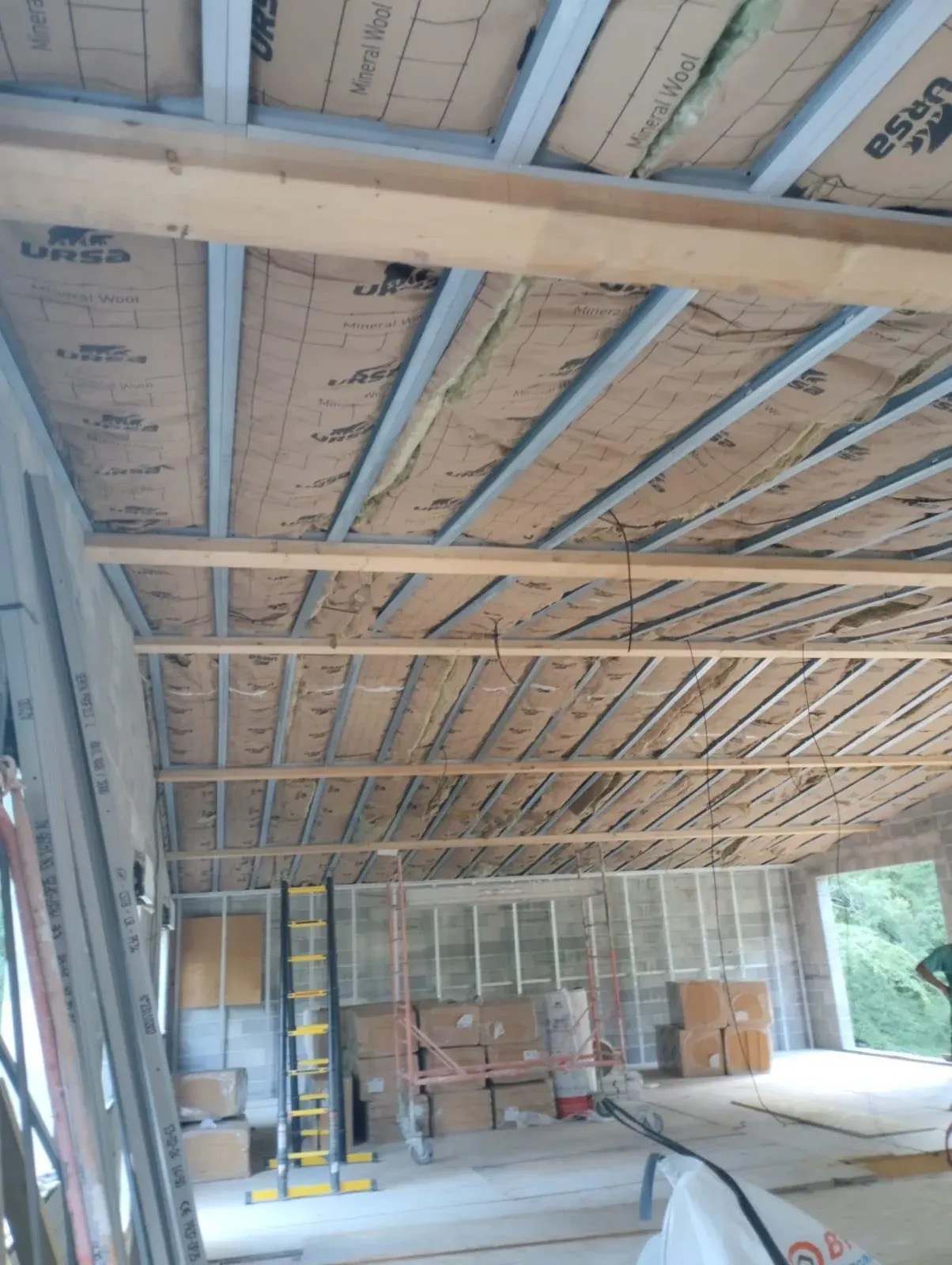 Ossature métallique de faux plafond garnie de laine minérale